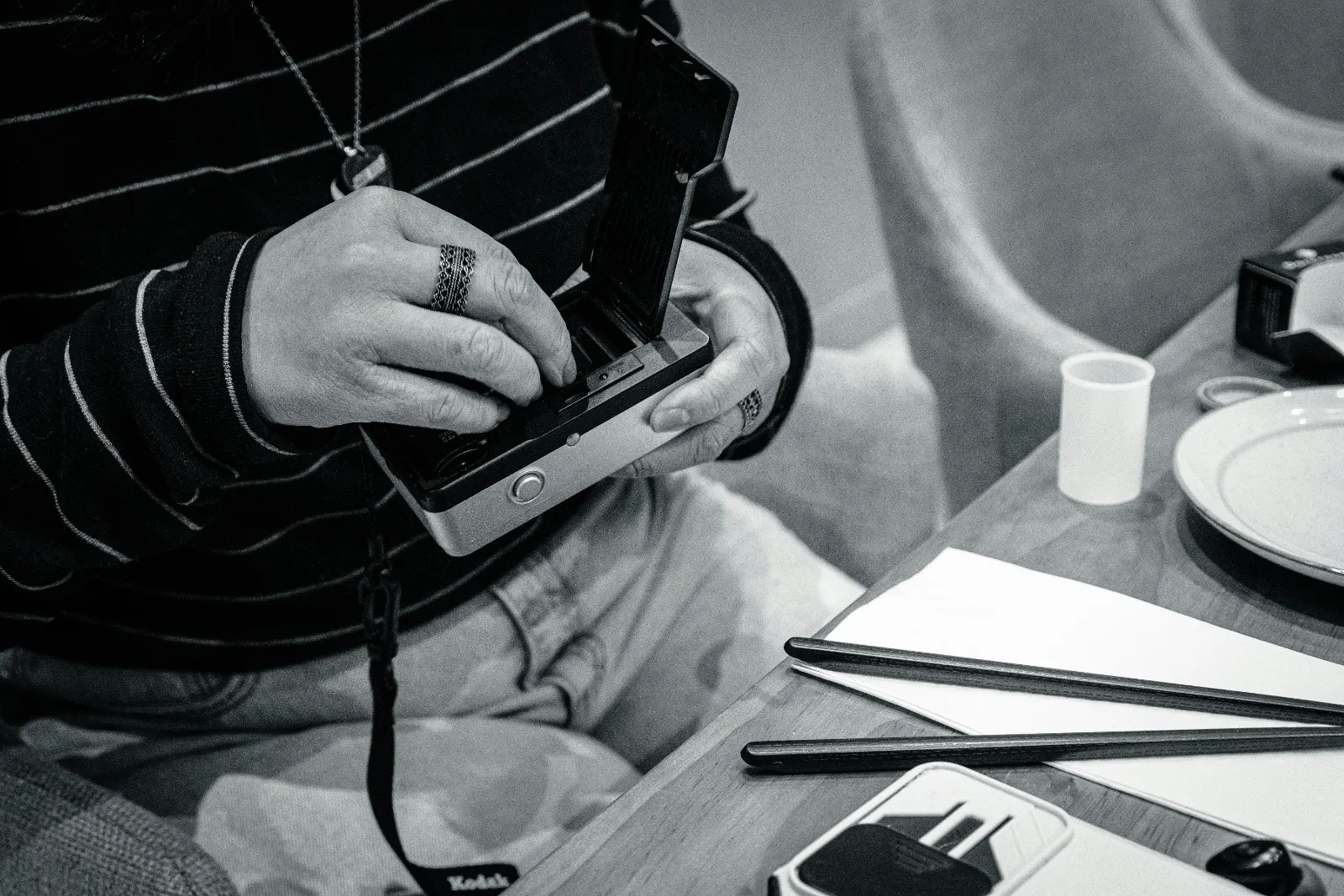 Hands using a tactile assistive device at a table