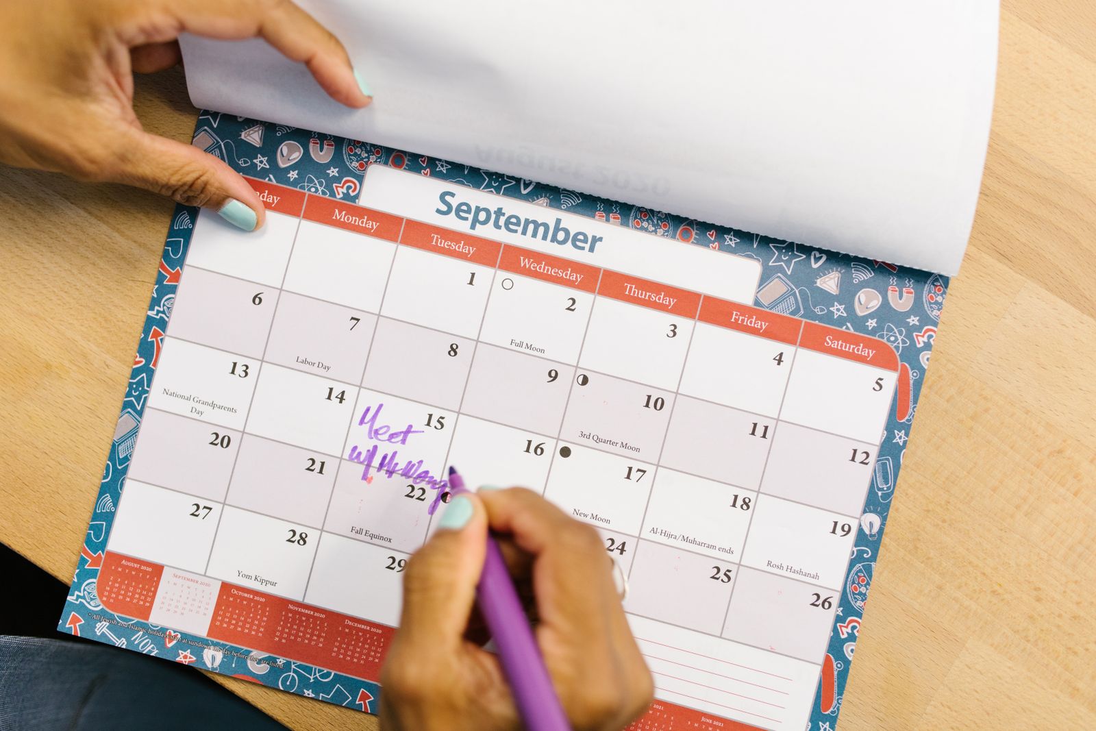 A person marking appointment buffer time on a calendar
