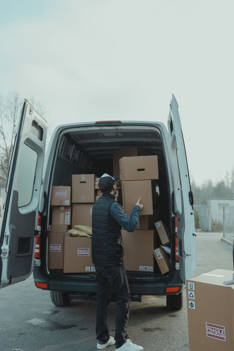 Service worker loading boxes into a van before a route