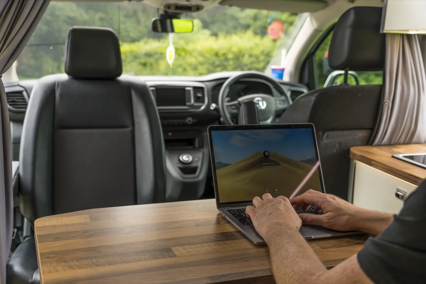 Mobile worker using a laptop inside a vehicle between visits