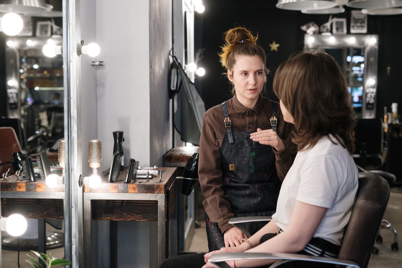 Beauty professional reviewing appointment details and client records before updating bookkeeping