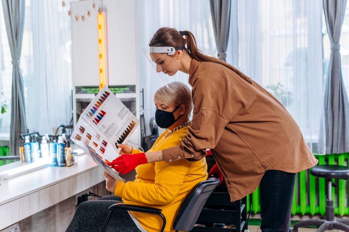 Beauty professional using colour samples during a client consultation