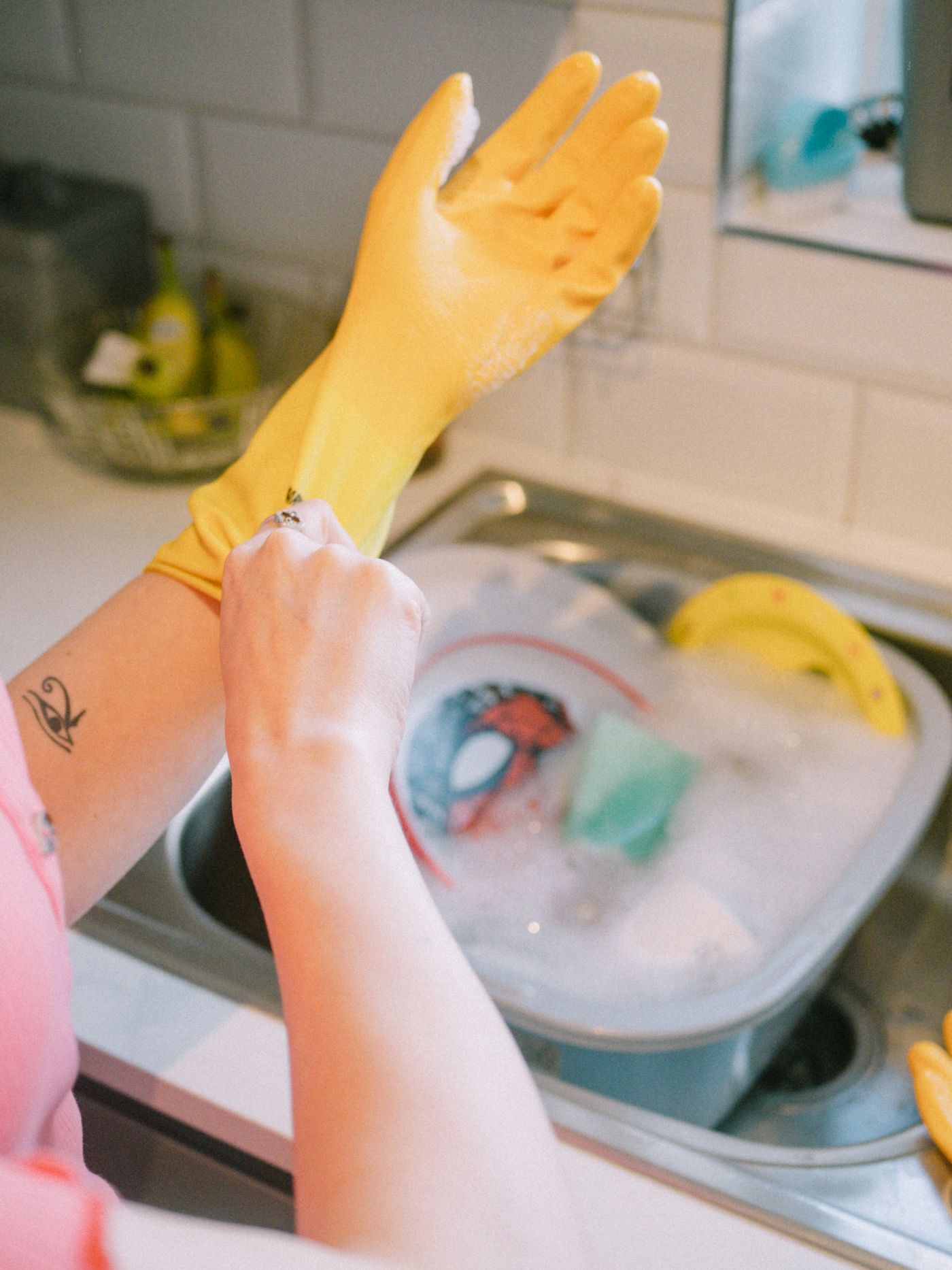 Cleaner putting on gloves before a kitchen clean