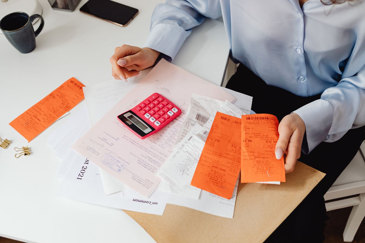 Receipts and calculator being reviewed for small business bookkeeping