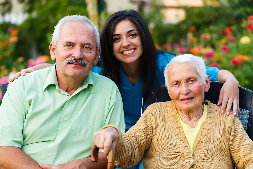 Professional speaking with an older client during a home visit