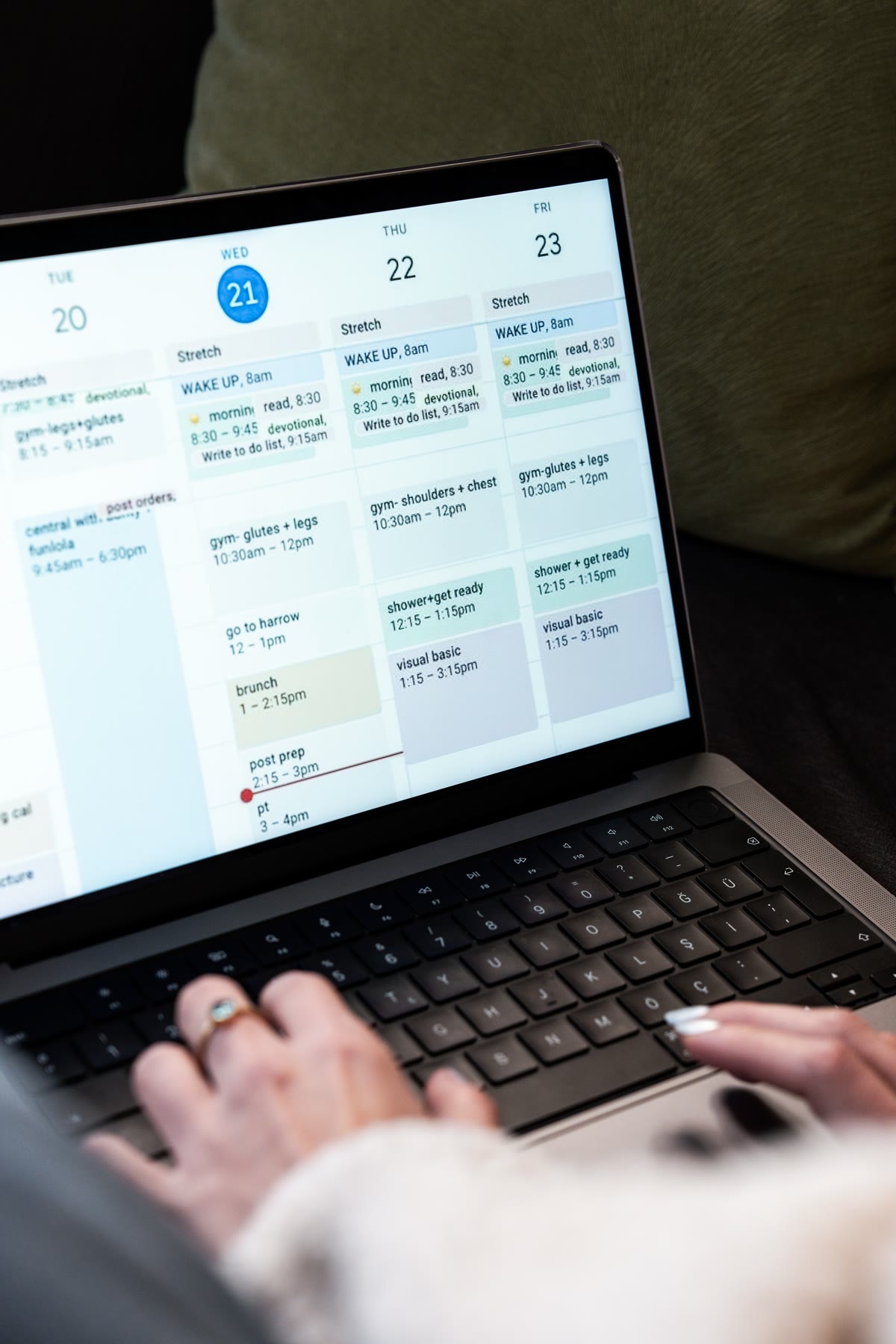 Person reviewing a weekly calendar on a laptop