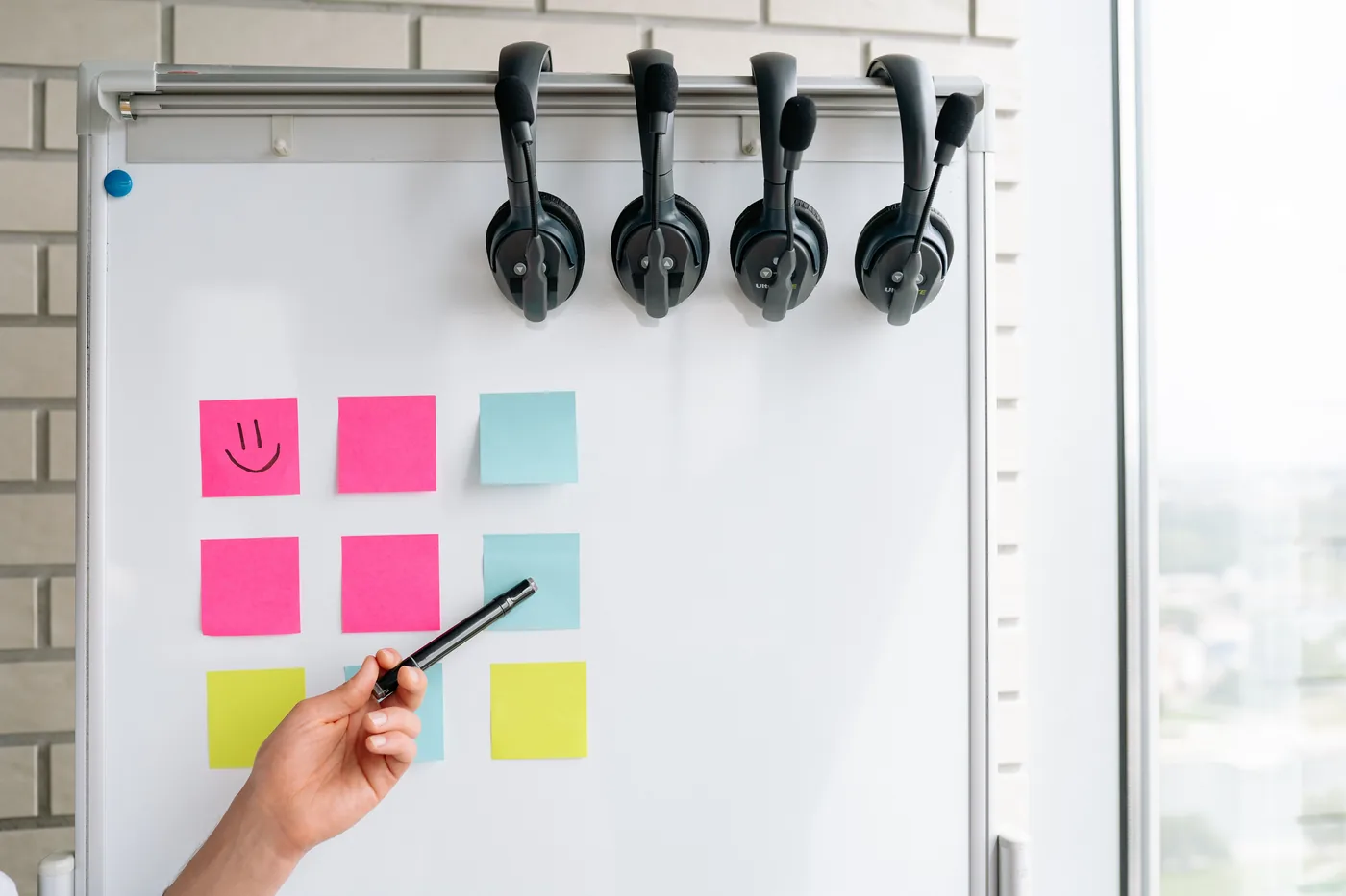 Shared planning board with colour coded notes and team headsets