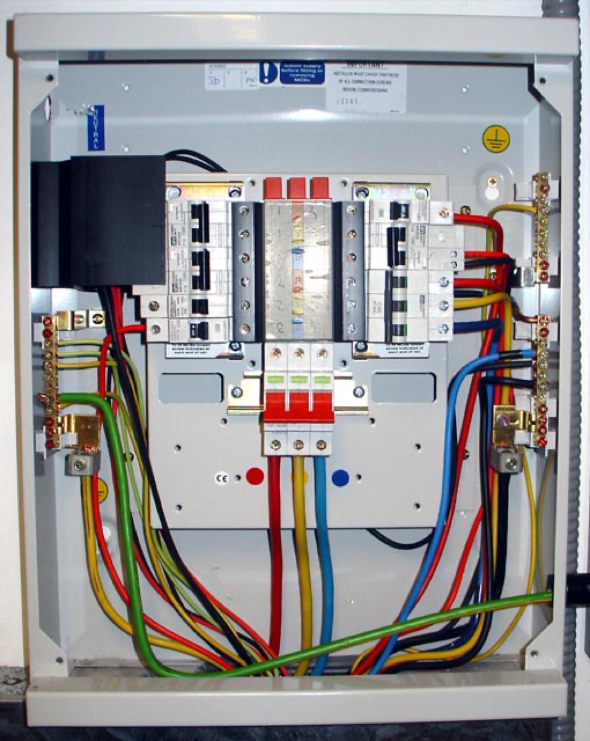UK electrical distribution board with wiring and circuit breakers