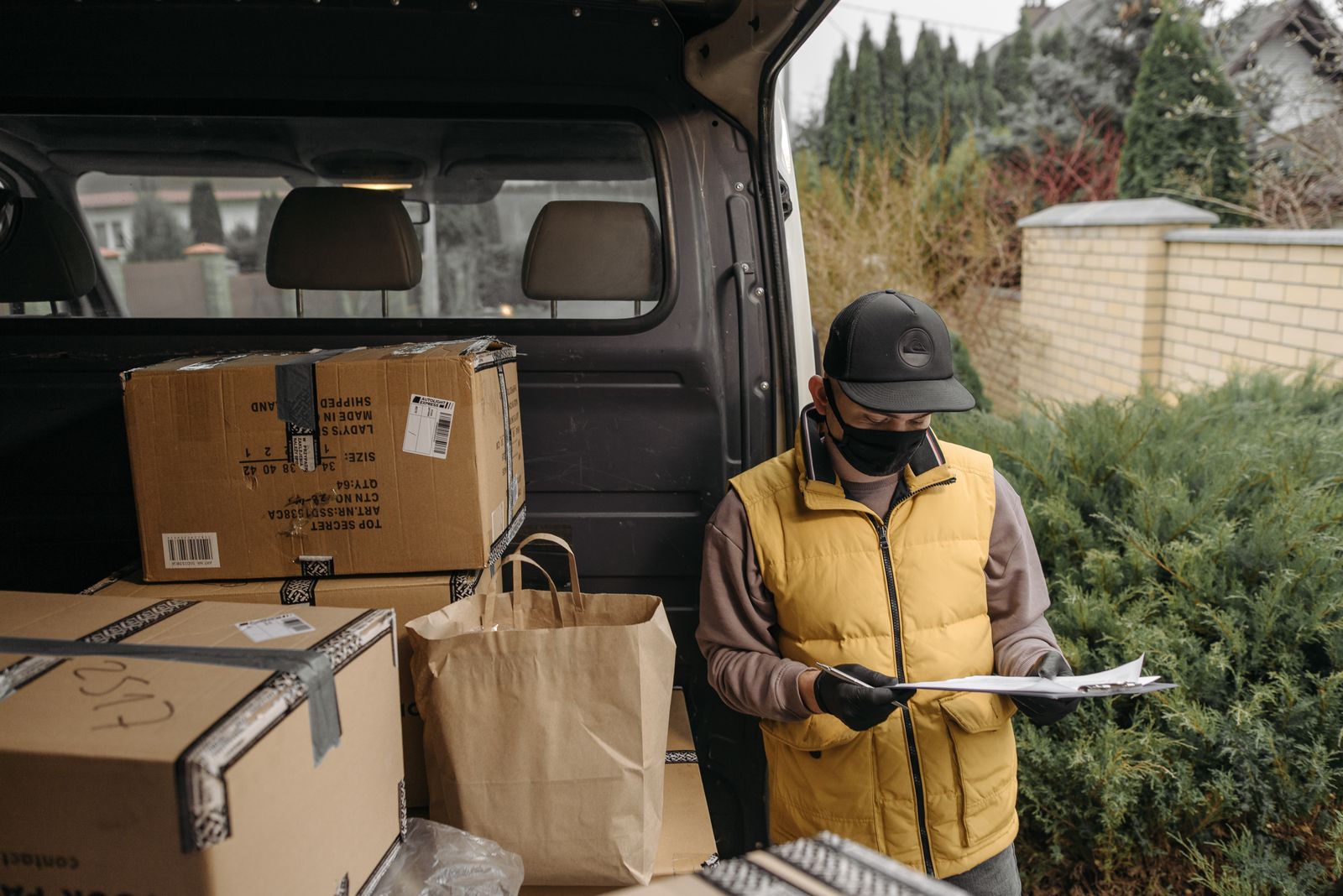 Mobile worker checking paperwork beside a van