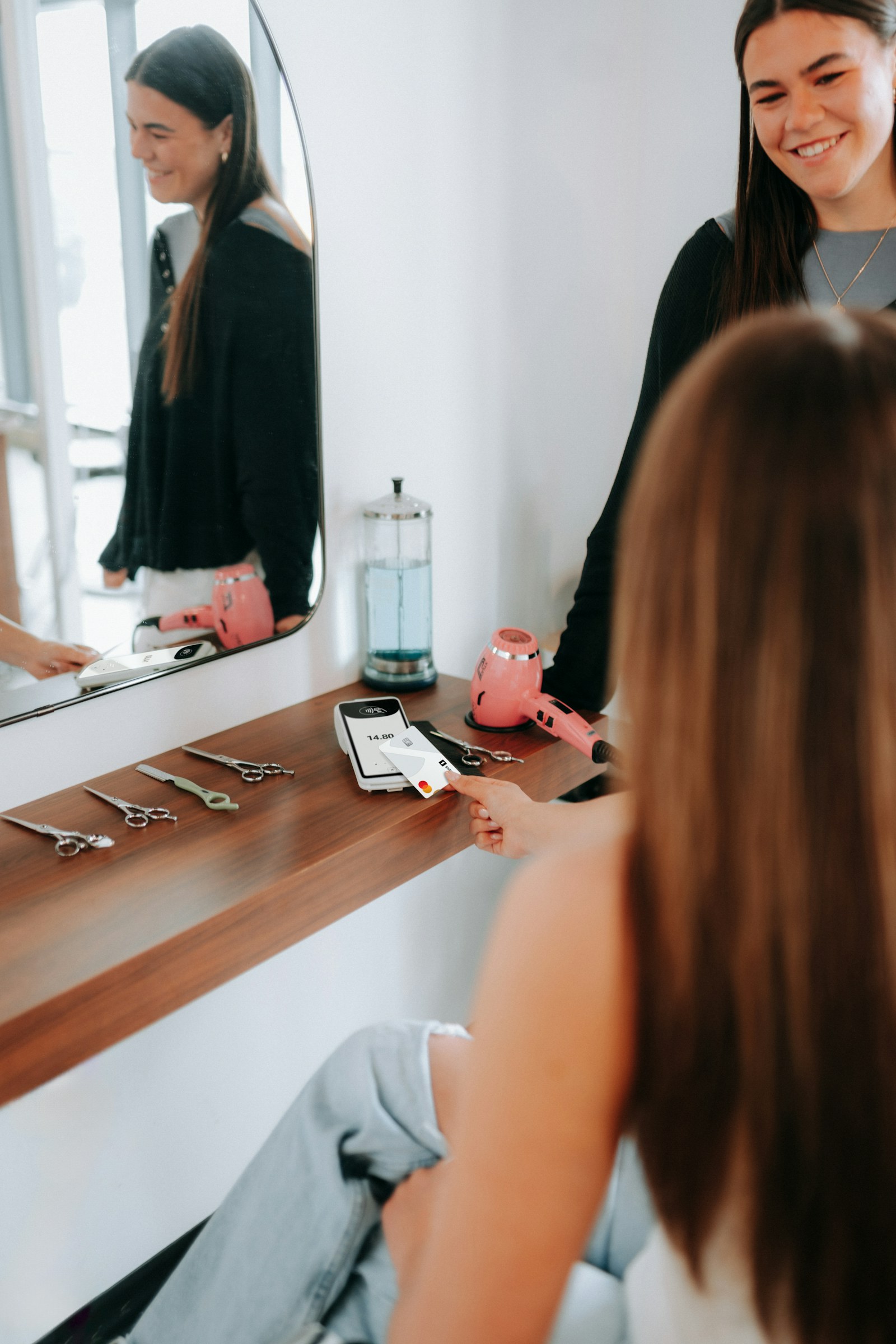 Client paying after a hair appointment in a salon