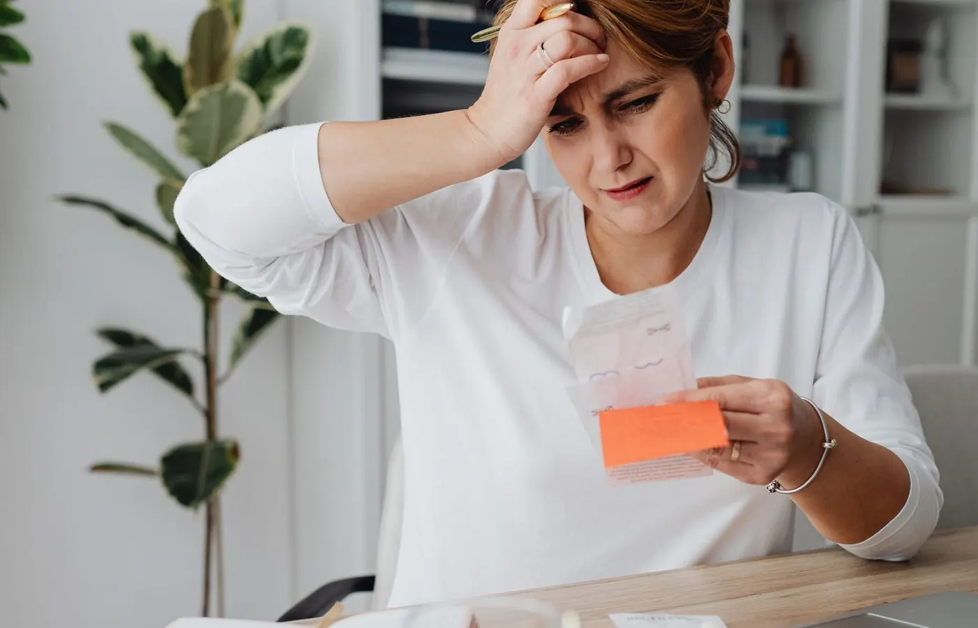 A small business owner reviewing receipts at a laptop