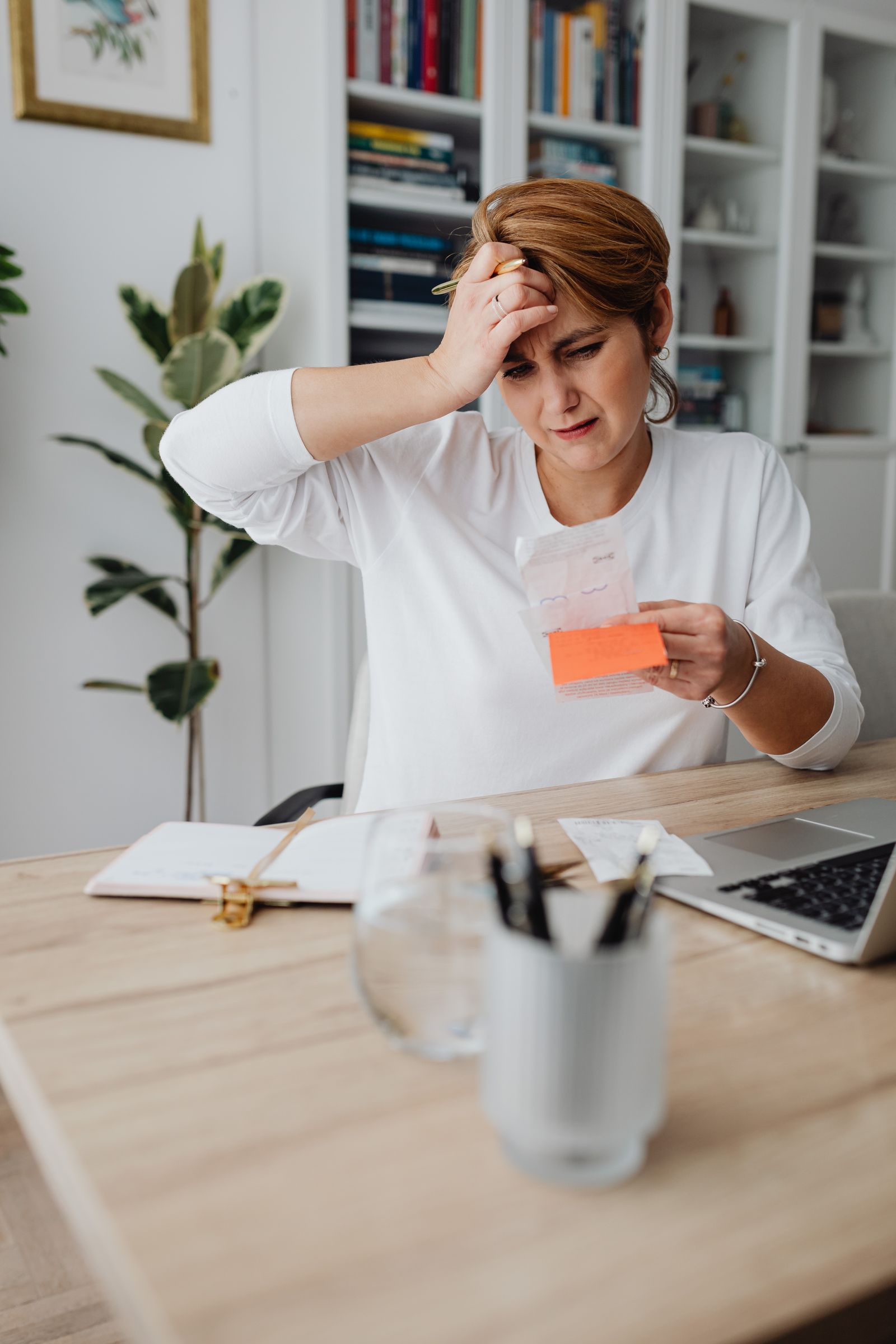 A small business owner reviewing receipts at a laptop