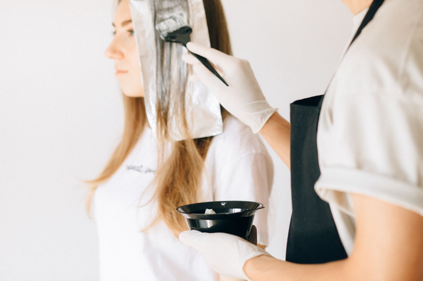 Hairdresser applying colour during an appointment