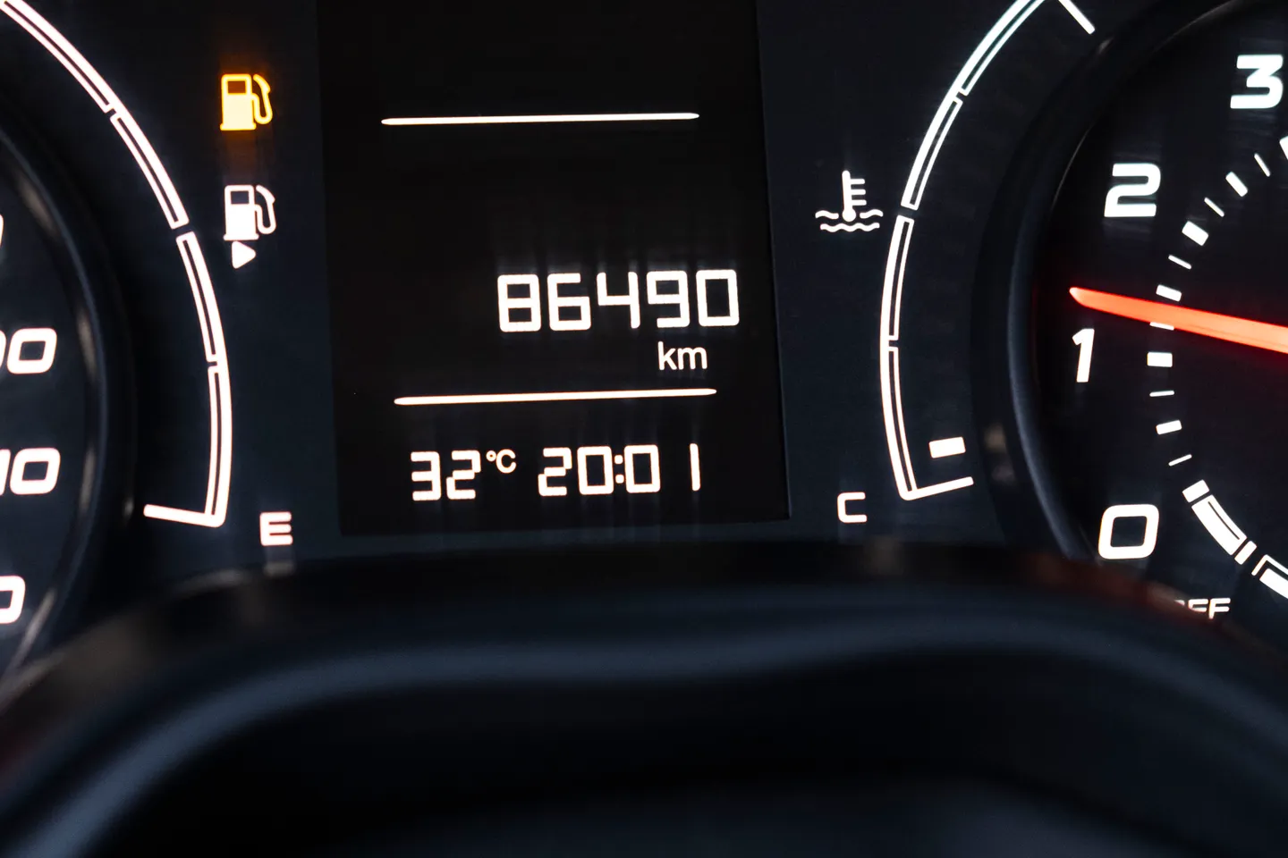 Car dashboard showing an odometer used to support a mileage record