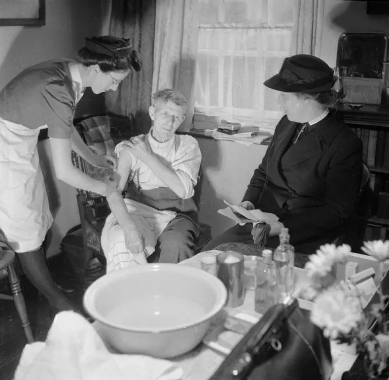 A district nurse visiting a patient at home