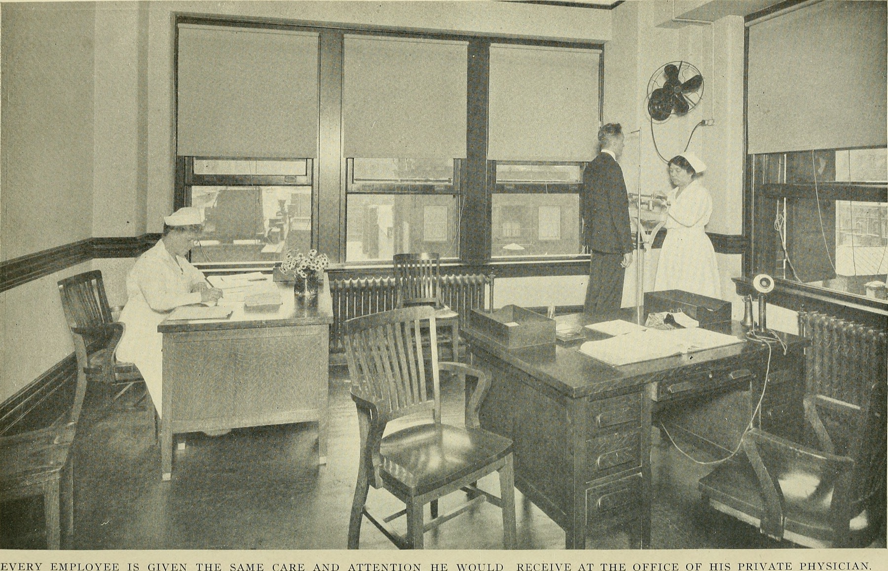 A public health nurse speaking with a family during a visit
