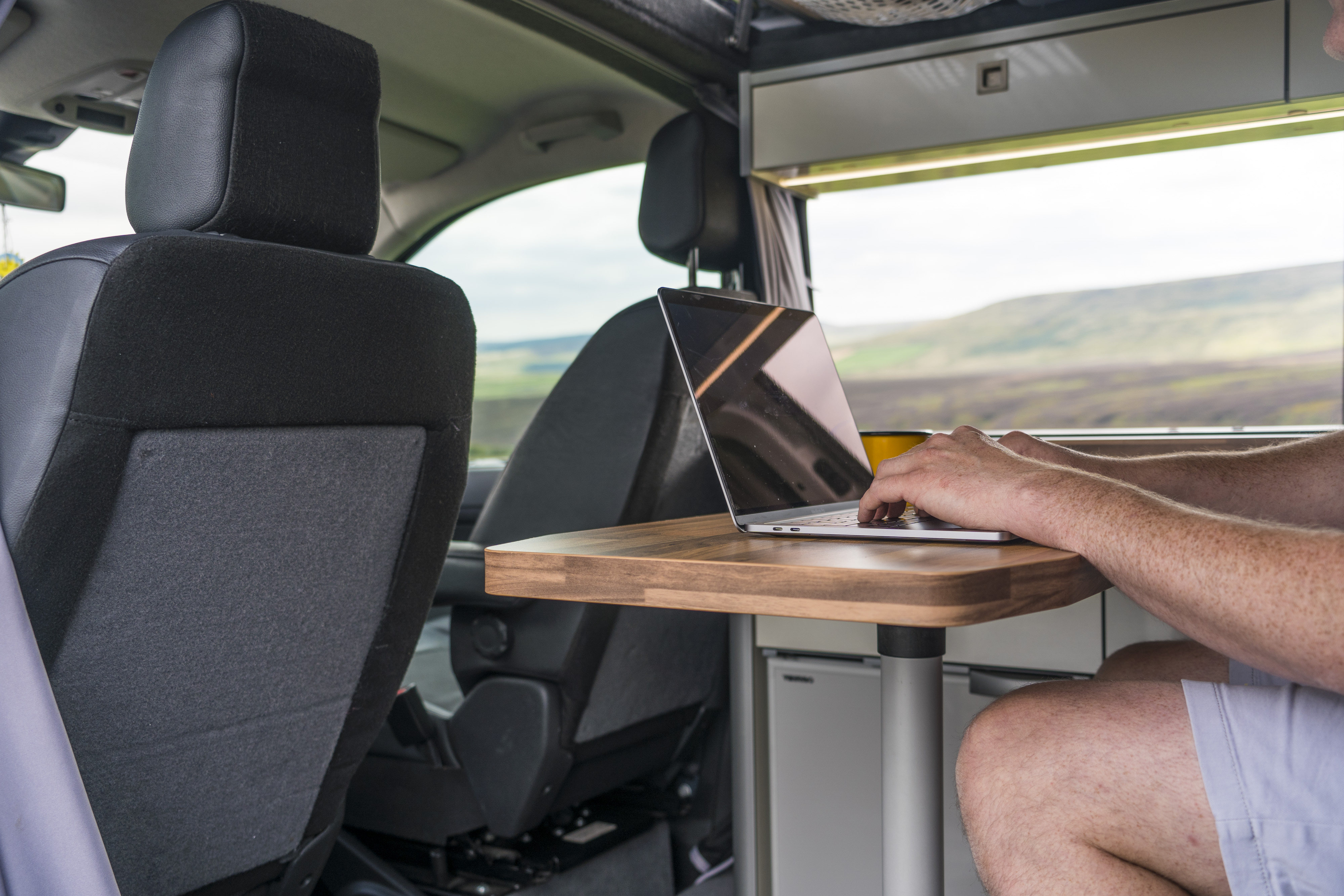 Mobile worker using a laptop inside a vehicle between visits