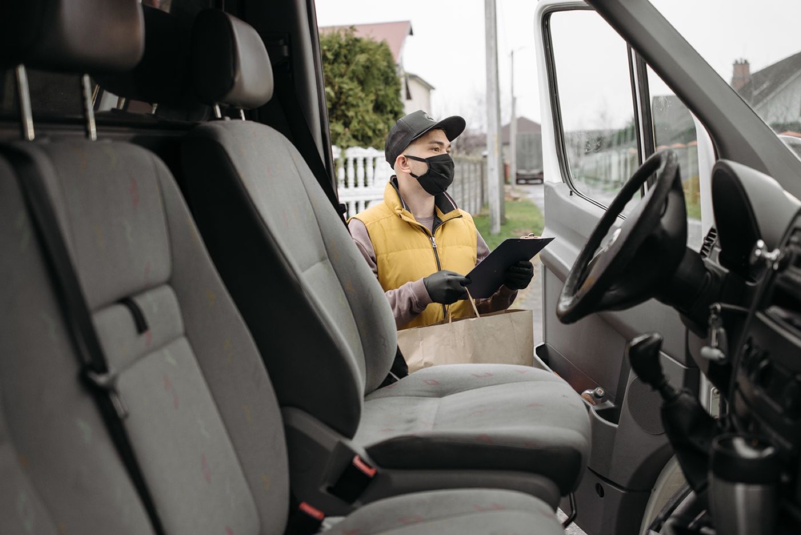Mobile worker checking visit details beside a van