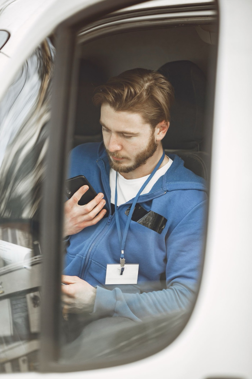 Mobile service worker checking the next appointment from a parked van