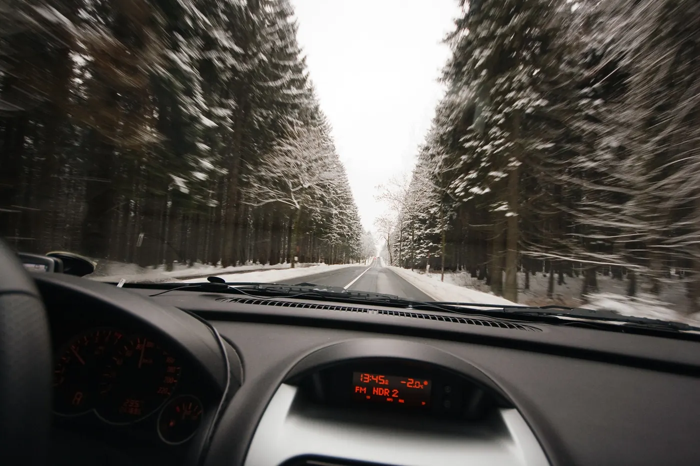 Car dashboard odometer during a road journey