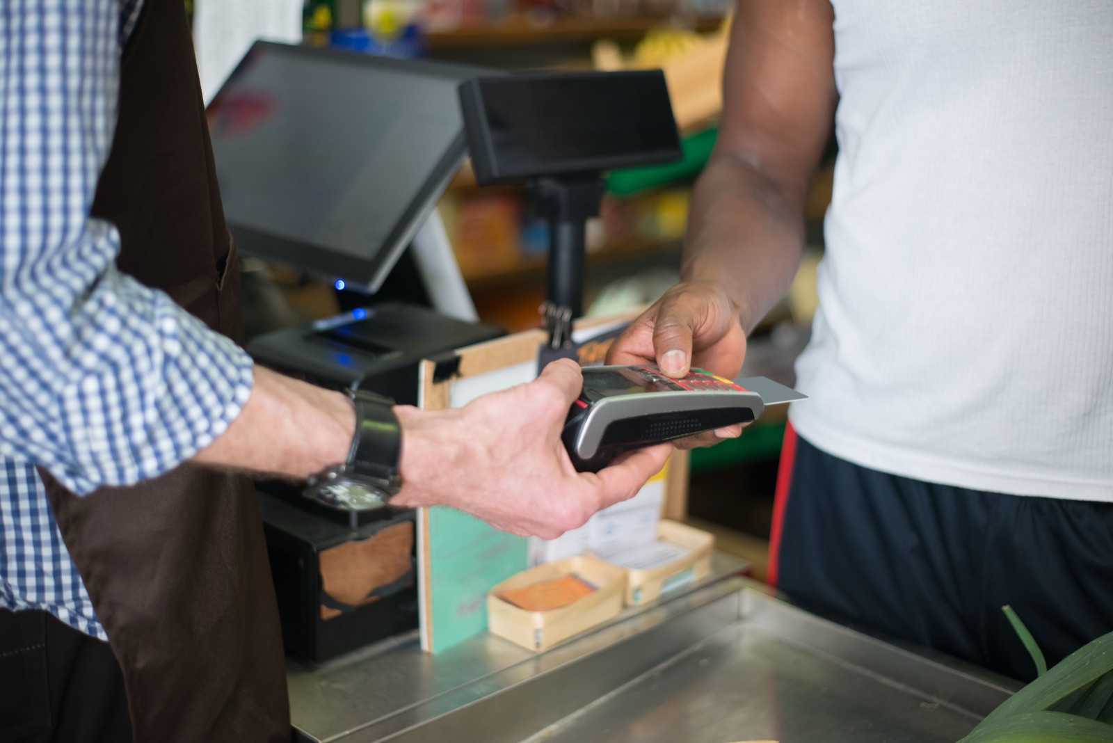 Customer making a card payment at a small business counter