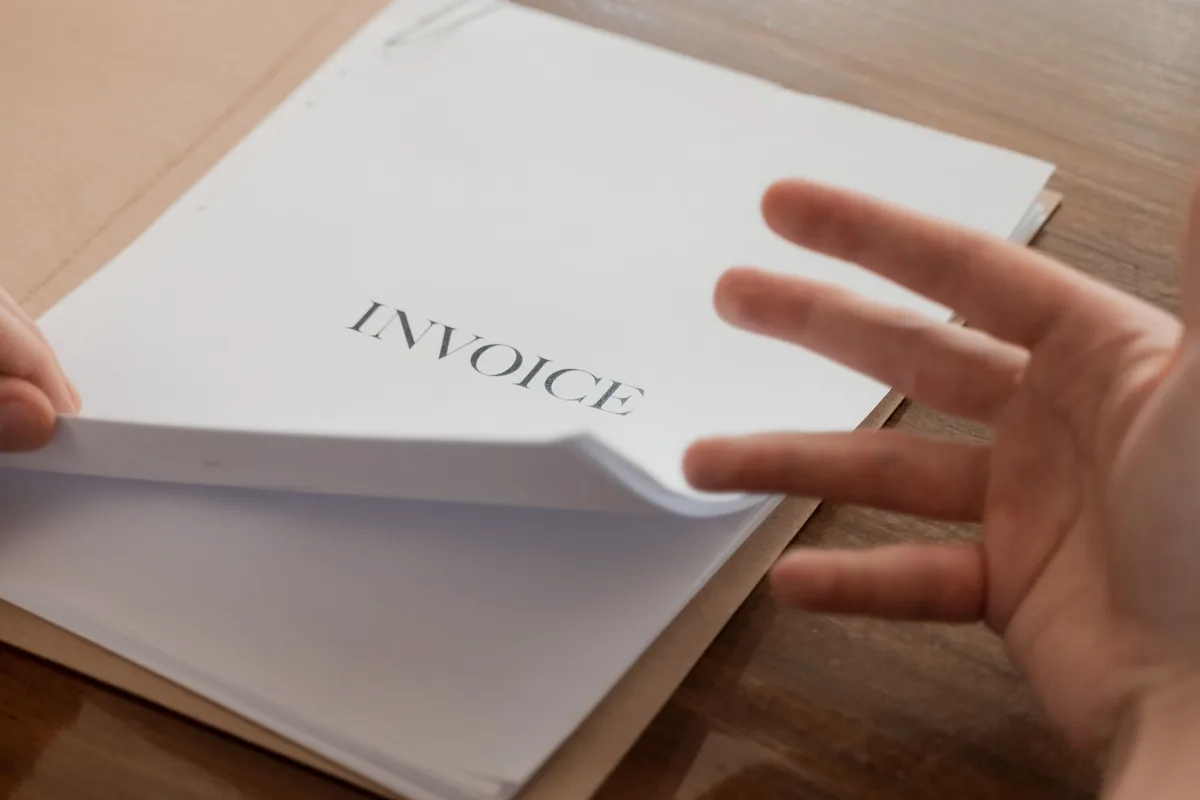 Person reviewing an invoice at a desk