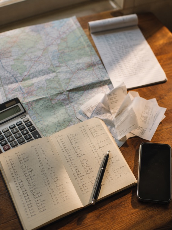 Mileage notes, visit route map and receipts spread across a mobile chiropodist desk